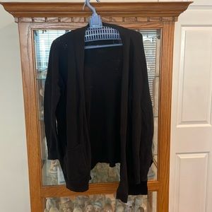 Cotton: on Black cardigan with side slits and pockets. Size small.